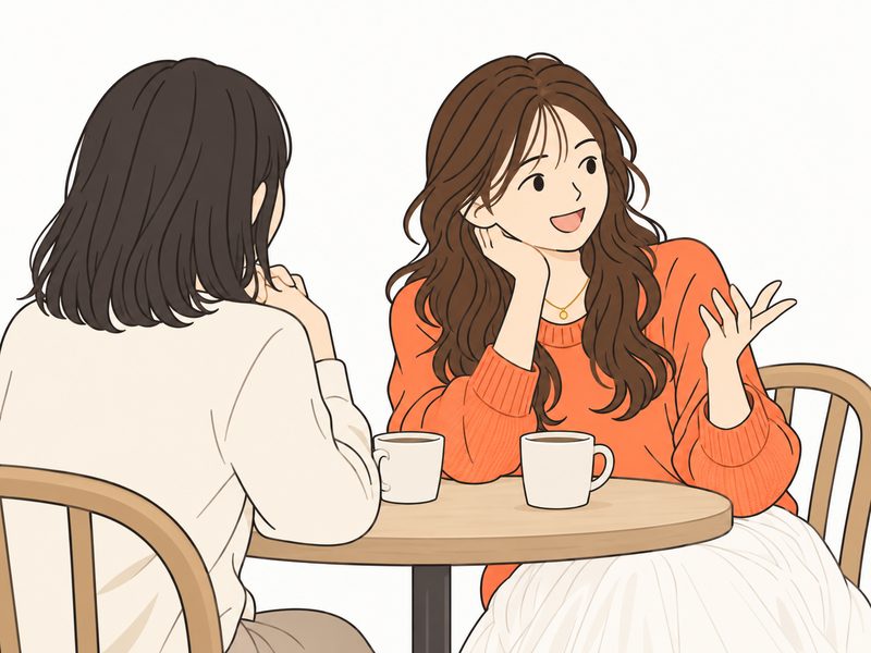 カフェで友達に恋の話をしながら笑う女性